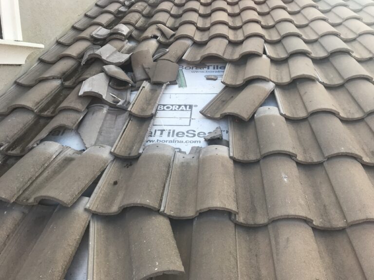 Roofer performing routine roof maintenance in Southwest Florida