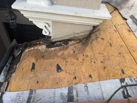 Rotted roof sheathing at a tile roof flashing wall in Riverstone, Naples FL